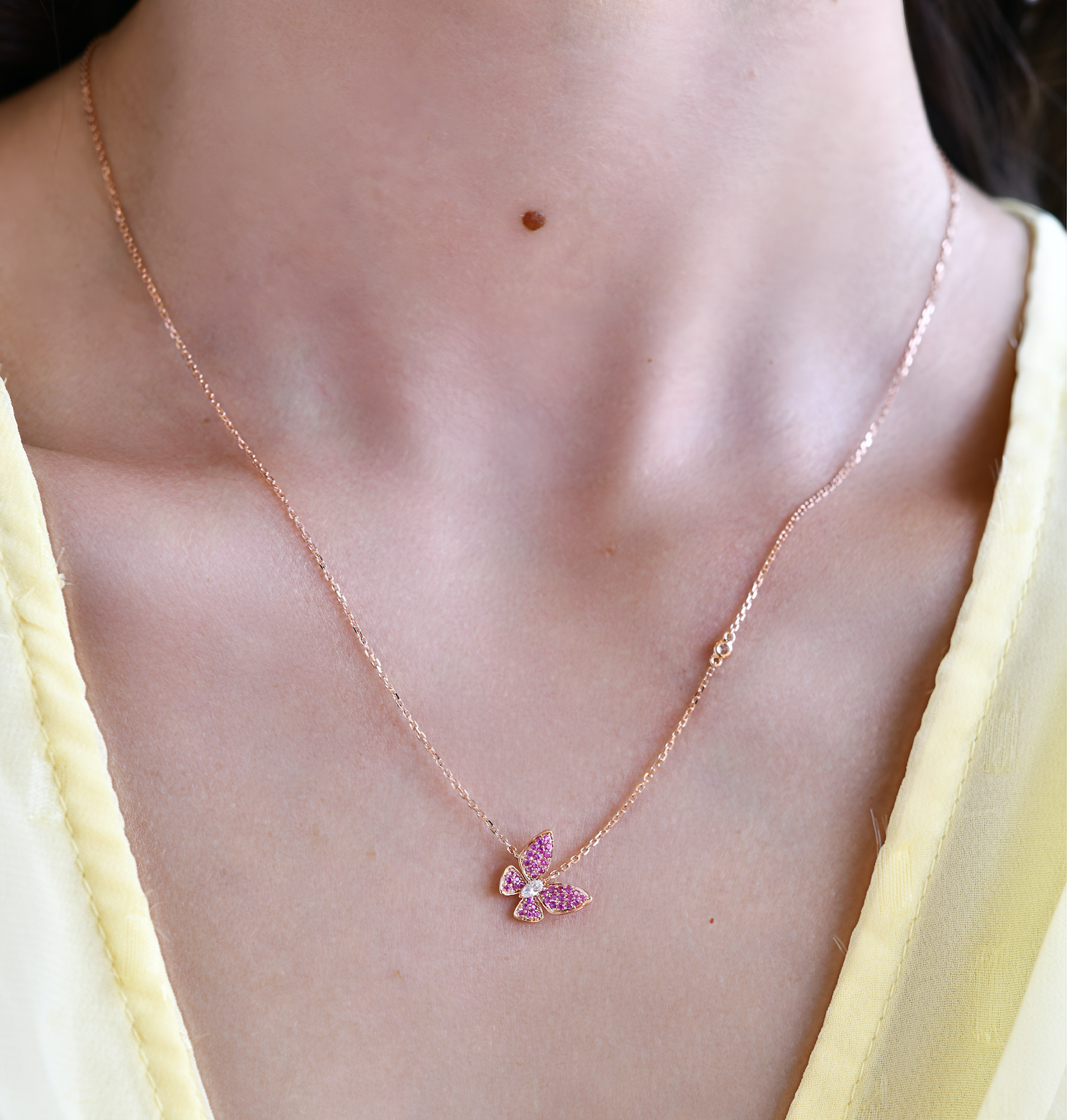 18K Rose Gold Pink Sapphire and Diamond Butterfly Necklace with model's neck