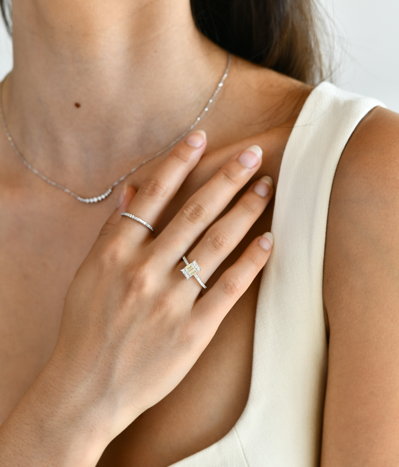 18K White Gold Baguette and Round Diamond Ring with model's hand