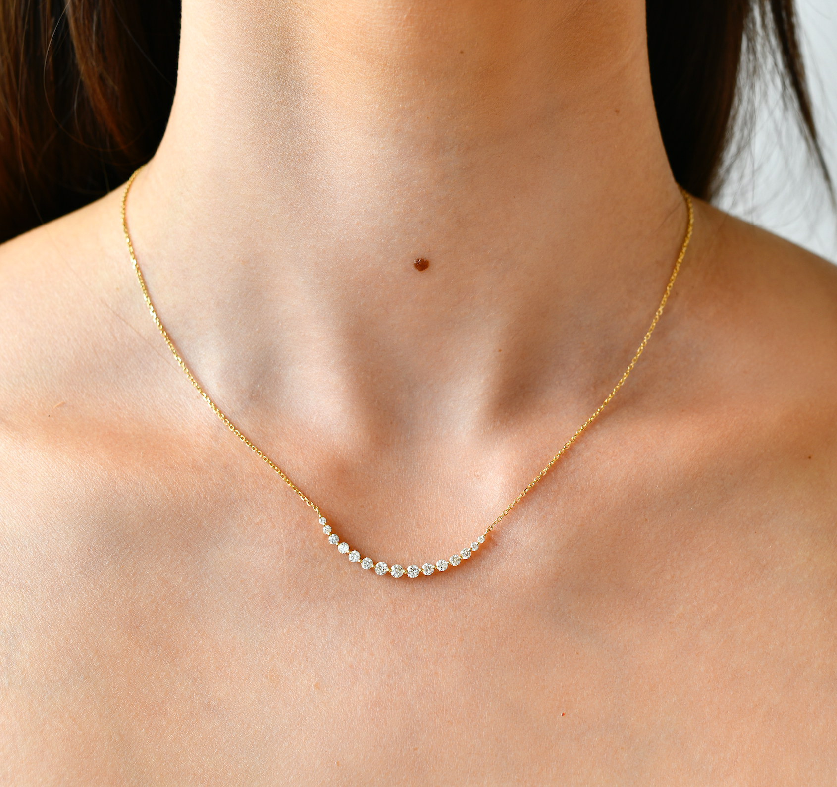 18K Gold Crescent Diamond Necklace with model's neck