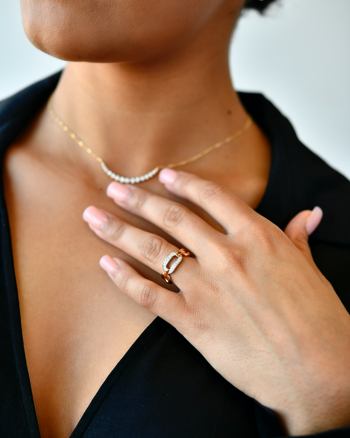 18K Rose Gold & White Gold Diamond Buckle Ring with model's hand